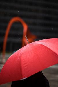 Close-up of wet red umbrella during rainy season