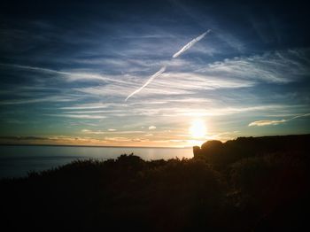 Scenic view of silhouette landscape against sky at sunset