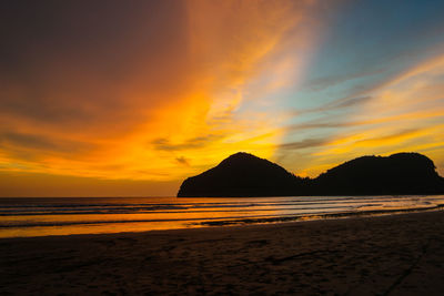 Scenic view of beach against sky during sunset