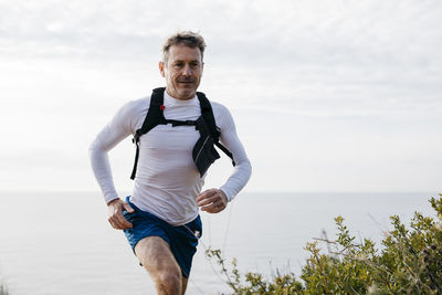 Portrait of man on beach against sky