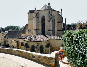 Rear view of men outside temple against building