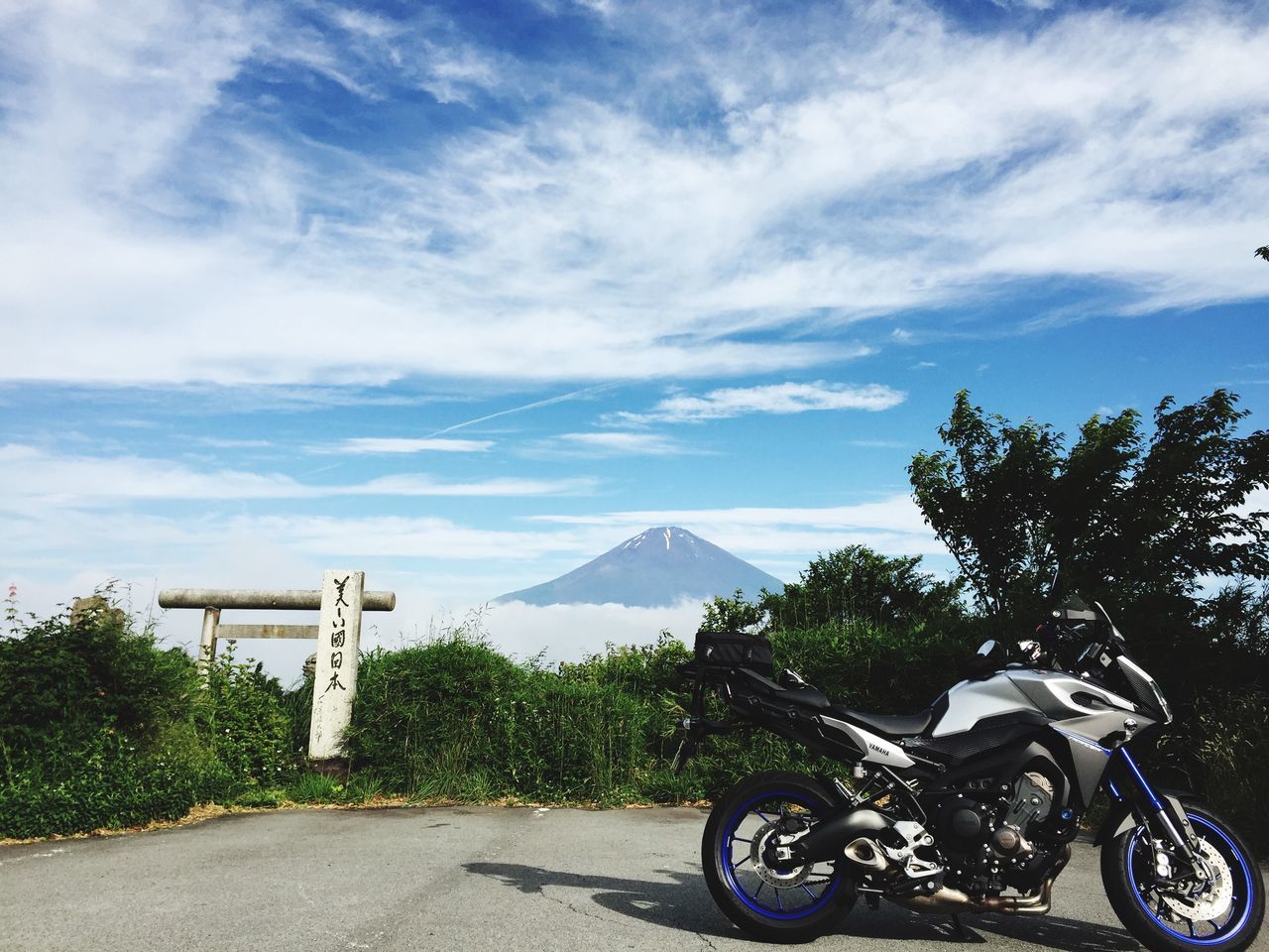 sky, transportation, mountain, bicycle, cloud - sky, land vehicle, mode of transport, tree, cloud, road, mountain range, parking, tranquility, parked, day, cloudy, tranquil scene, stationary, nature, scenics