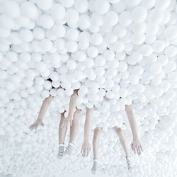 Couple enjoying in white ball pool