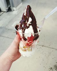 Cropped image of woman holding ice cream cone