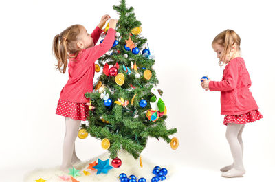 Full length of a girl wearing christmas tree