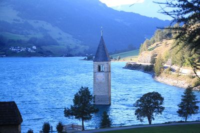 Scenic view of building and mountains against sky