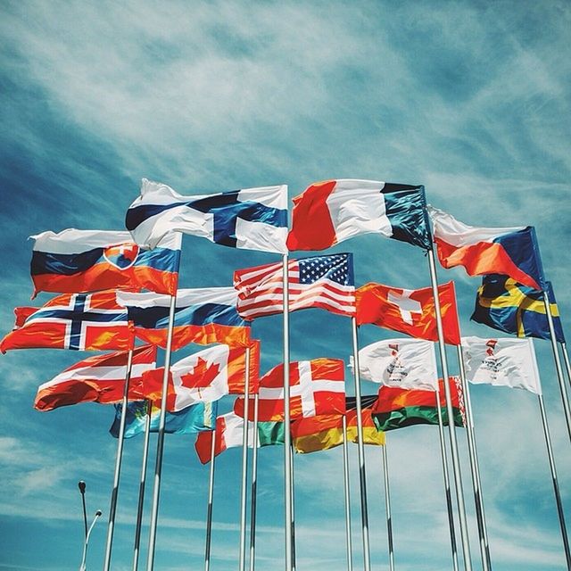 patriotism, flag, national flag, identity, american flag, wind, sky, low angle view, striped, red, pole, culture, flag pole, cloud - sky, pride, blue, cloud, waving, day, multi colored