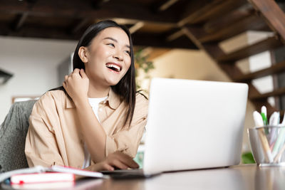 Young woman using laptop at office