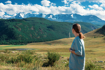 Rear view of woman looking at mountains