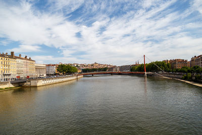 View of bridge over river against cloudy sky