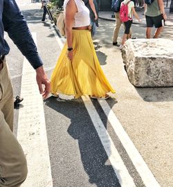 Low section of people walking on road