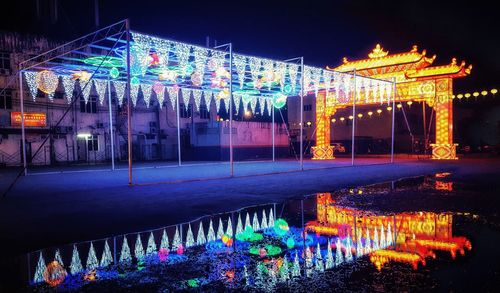 Illuminated building against sky at night