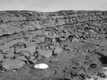 View of rocks on land against sky