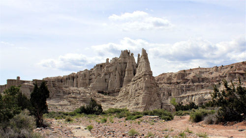 Rock formations on landscape against sky