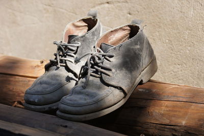 High angle view of shoes on wooden plank