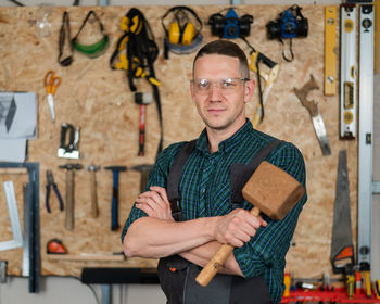 Portrait of smiling man standing in workshop