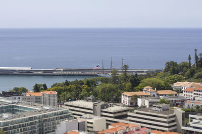 High angle view of buildings and sea against sky