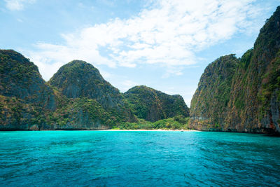 Scenic view of sea and mountains against sky