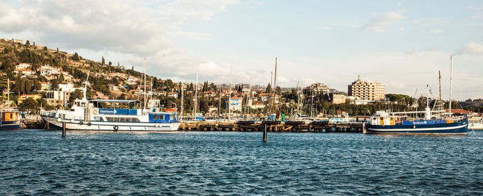 Boats moored at harbor