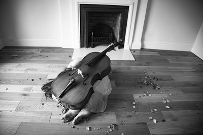 Man playing piano on hardwood floor at home