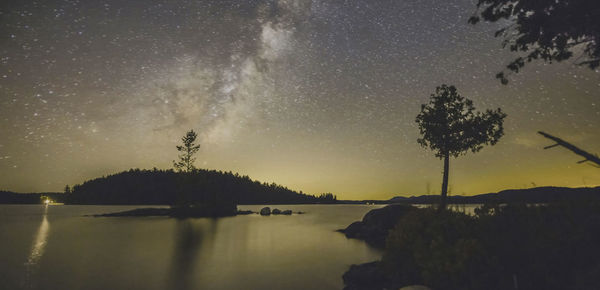 Scenic view of lake against sky at night