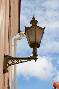 Low angle view of street light against building