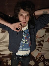 Young woman standing on sofa