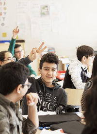 Teenage boy showing peace sign