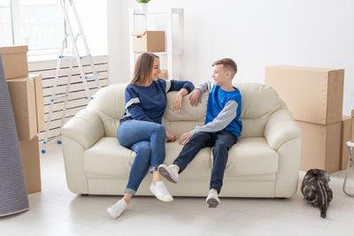 Young couple sitting on sofa at home