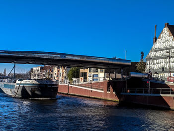 View of bridge over river against blue sky