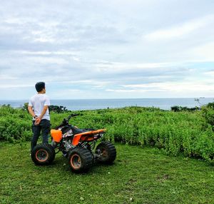 Man and tractor on field against sky