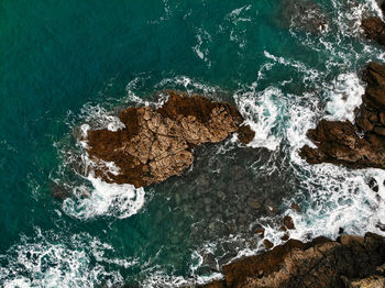 High angle view of rock formations at sea shore