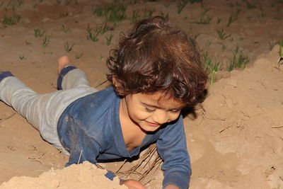 High angle view of boy on sand at beach