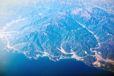 Aerial view of landscape by sea