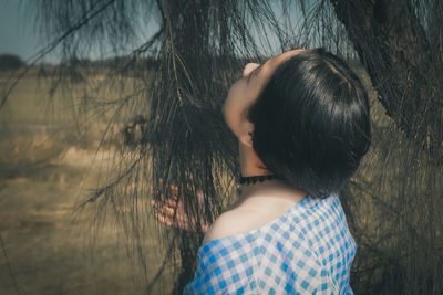 Rear view of woman standing by plants
