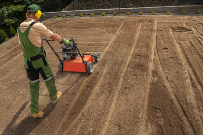 Rear view of man working on field