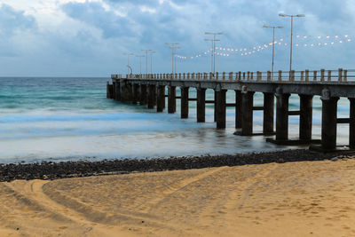 Pier over sea against sky