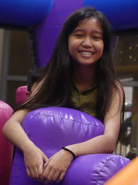 Portrait of young woman sitting in gym