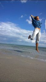 Woman jumping on beach