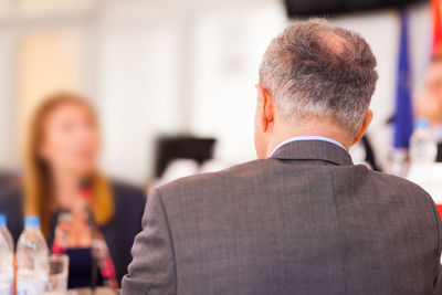 Rear view of businessman at conference