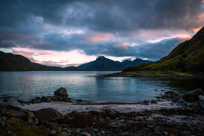 Scenic view on the beach and mountains against sunset sky, lofoten, norway
