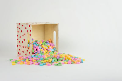 Close-up of multi colored candies against white background