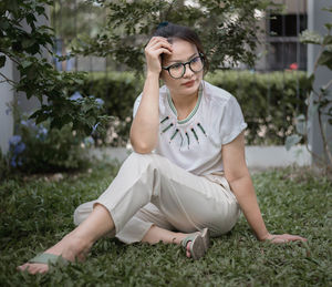 Young woman sitting on field