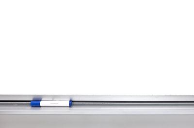 Close-up of pen on table against white background