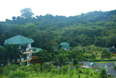 Scenic view of trees and buildings against sky