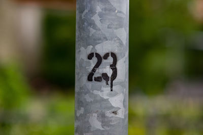 Close-up of text on metal pole