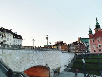 Buildings in city against clear sky