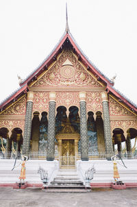 Facade of temple against building