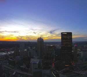 Aerial view of city against cloudy sky