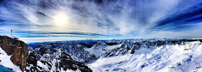 Scenic view of snow covered mountains against sky
